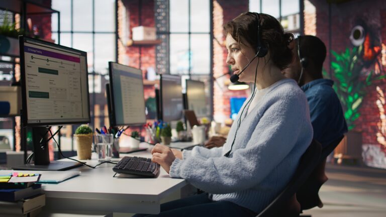 Call center team of agents wearing headset assisting customers