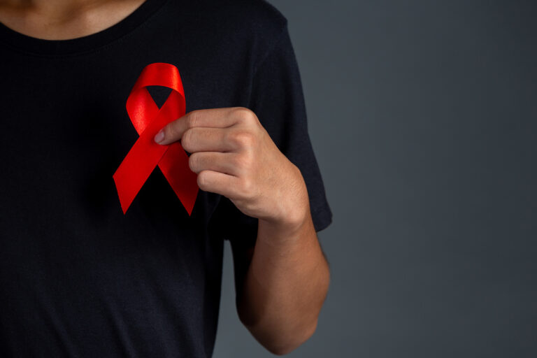 Men holding red ribbons. Conceptual awareness. HIV