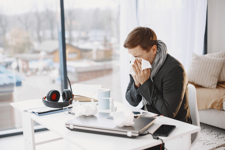 Young man ill with flu in office