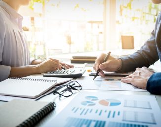 business man financial inspector and secretary making report, calculating or checking balance. Internal Revenue Service inspector checking document. Audit concept